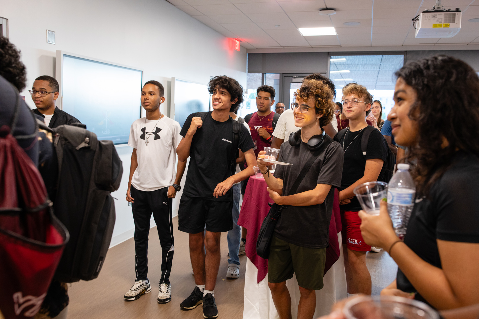 Group of students looking at something off screen.