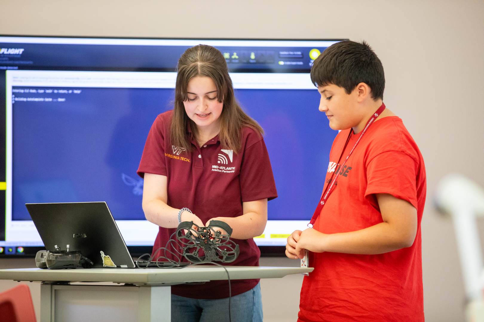 Virginia Tech instructor helping a student with his drone
