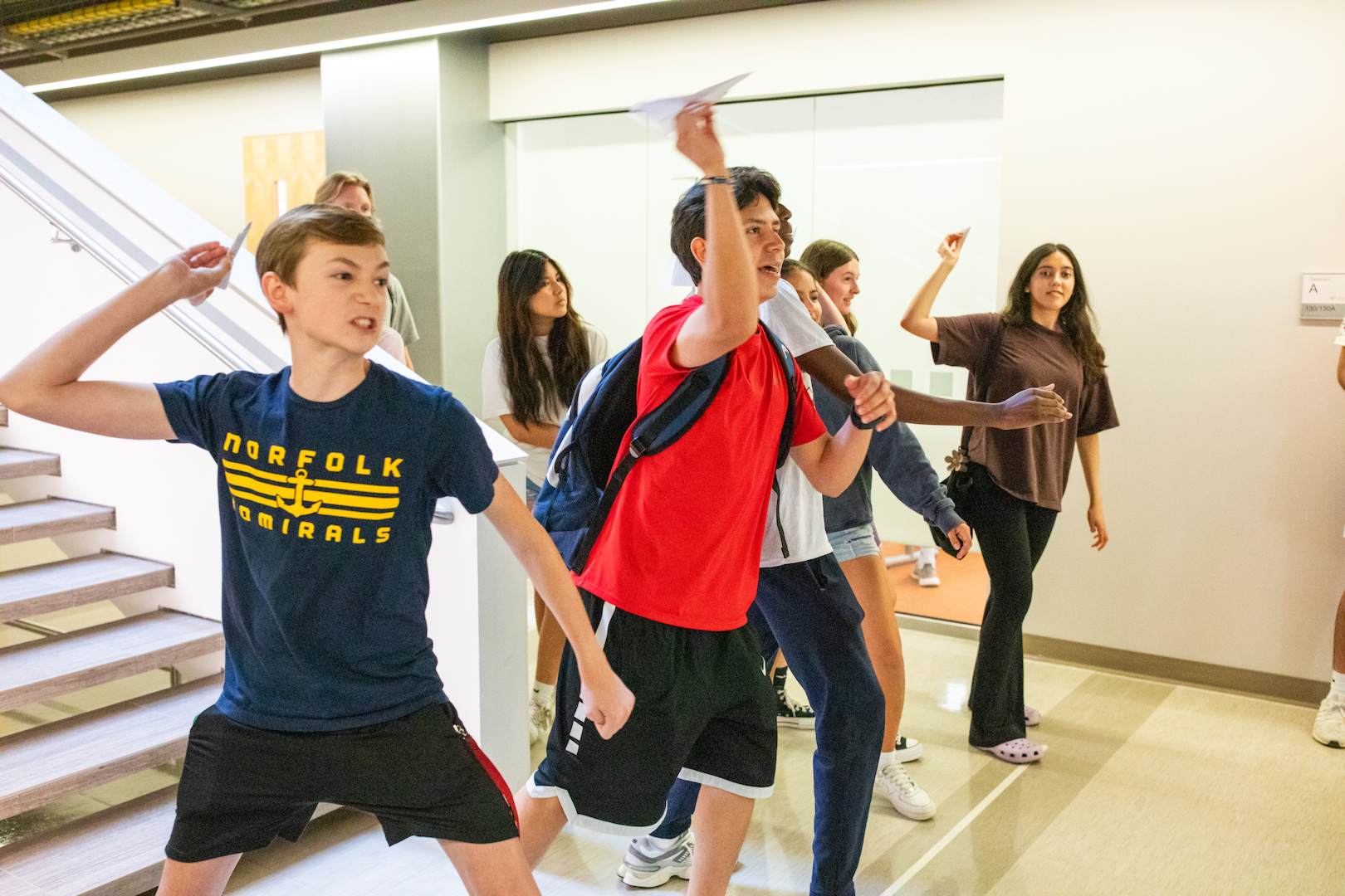 Several students throwing paper planes